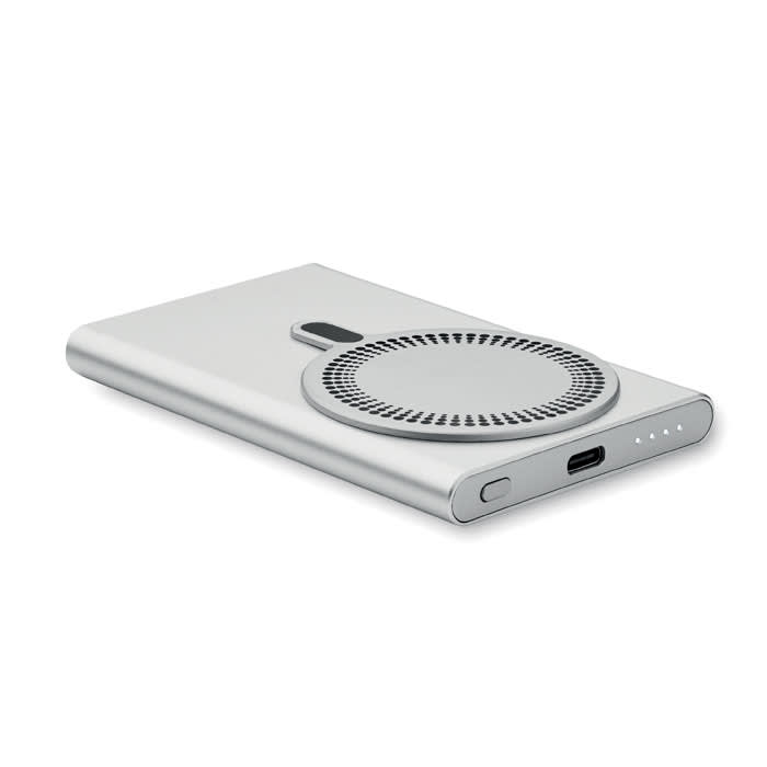 A power bank in silver with a circular design, featuring a USB-C port and LED indicator lights.
