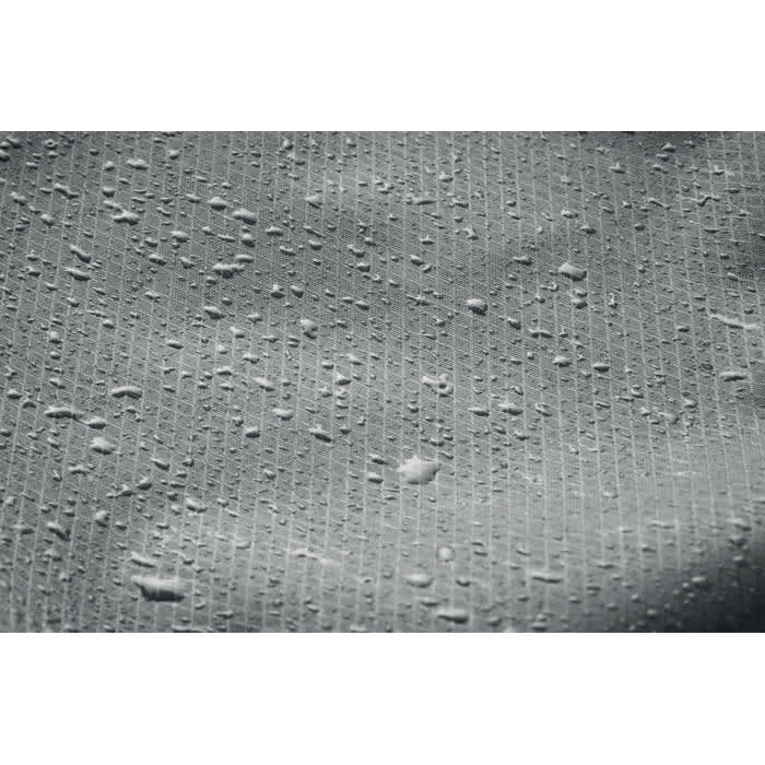 A textured surface with water droplets, showcasing a light grey colour and a pattern of small ridges.
