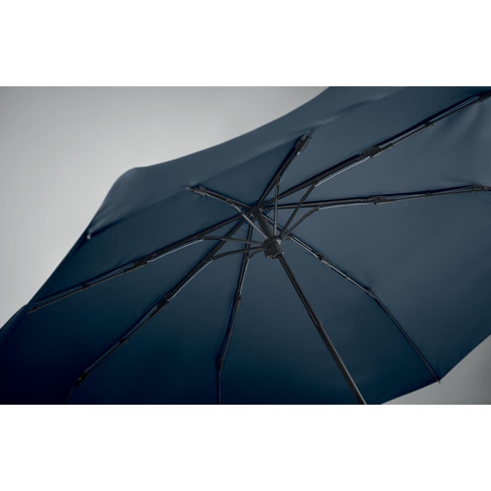 A navy umbrella with a black frame, showcasing the interior structure and spines. Includes a logo on the handle.