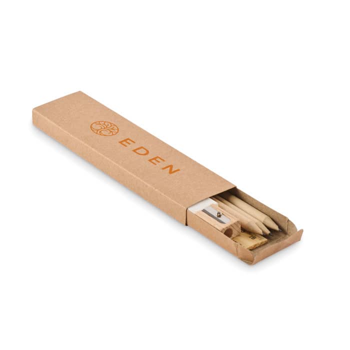 A stationery set in a brown cardboard box, including pencils, a sharpener, and a branding logo.