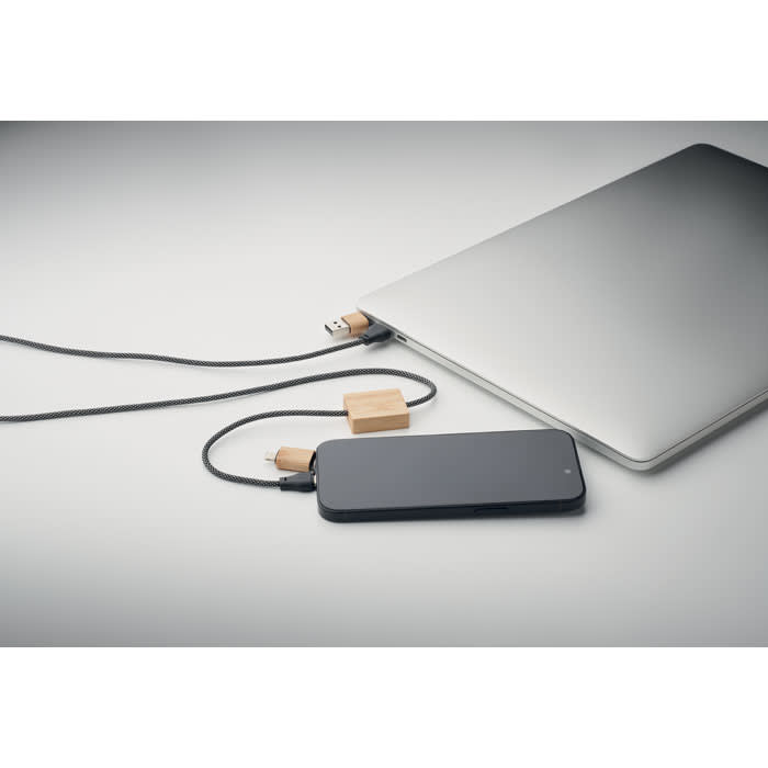 A charging cable connected between a smartphone and a laptop, featuring a wooden connector.