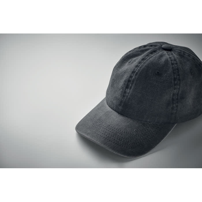 A black cap with a curved brim, featuring a textured fabric. The cap is positioned at an angle on a light background.