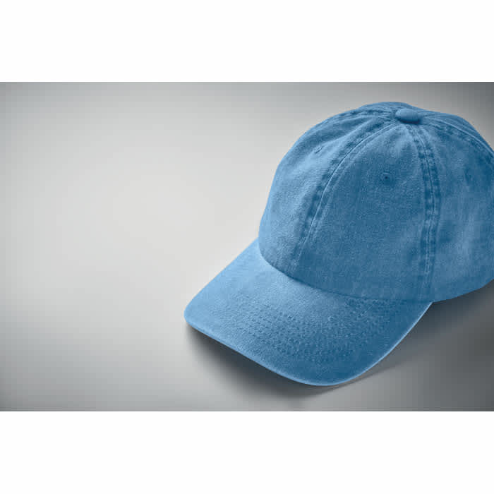A blue cap with a curved brim, featuring stitching details and a casual design. It has a round top and soft fabric.