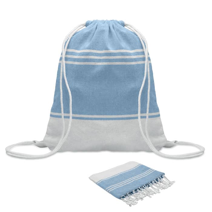 A blue and white drawstring bag with a matching patterned towel beside it. Both items feature simple stripes.