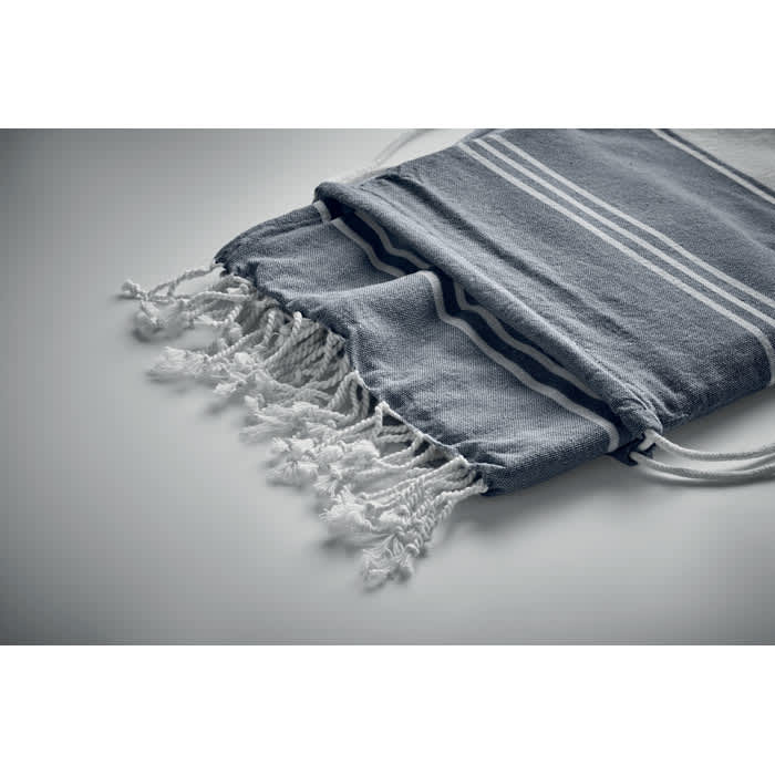 A grey towel with white stripes and fringes, folded and tied with drawstrings. It has a simple branding logo.