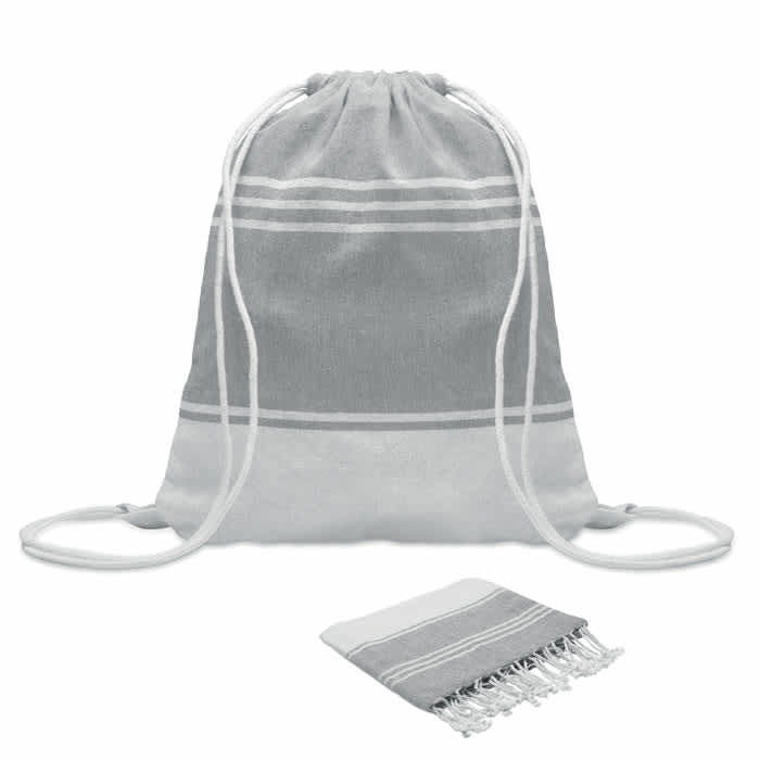 A drawstring bag in grey and white with a matching small towel. The bag features white drawstrings.