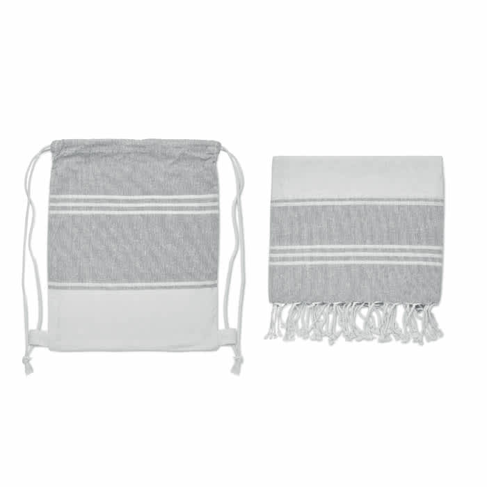 A drawstring bag and a towel, both in grey and white with stripes and tassels. The bag features a logo.