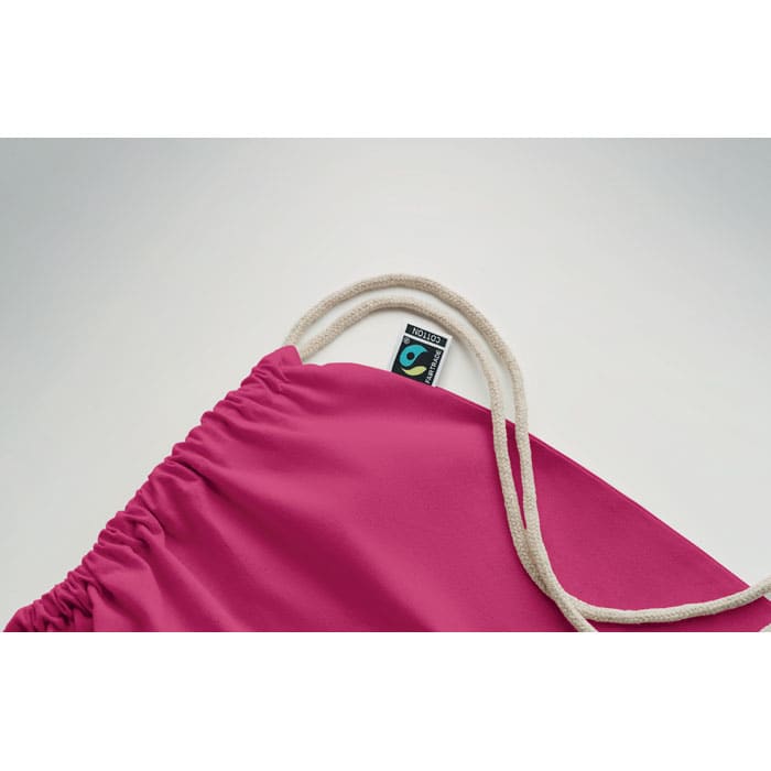 A pink drawstring pouch featuring a white cord and a small logo at the top.