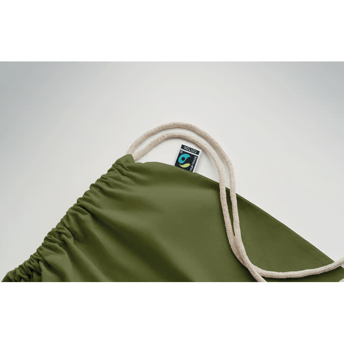 A green drawstring bag with a cream-coloured cord and a small logo tag attached.