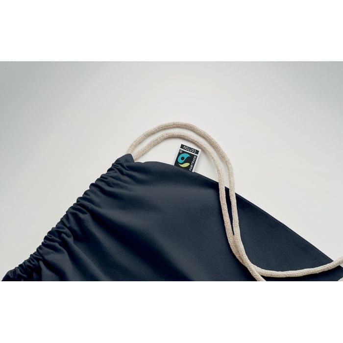 A dark navy drawstring bag with a cream-coloured cord and a small logo on the tag.