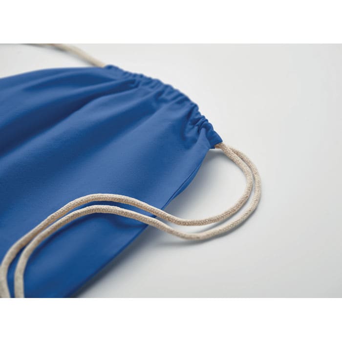 A blue drawstring bag with beige cords, featuring a gathered top.