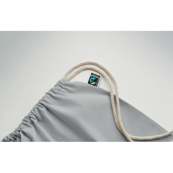 A drawstring bag in light grey with a natural-coloured cord and a logo tag on the side.