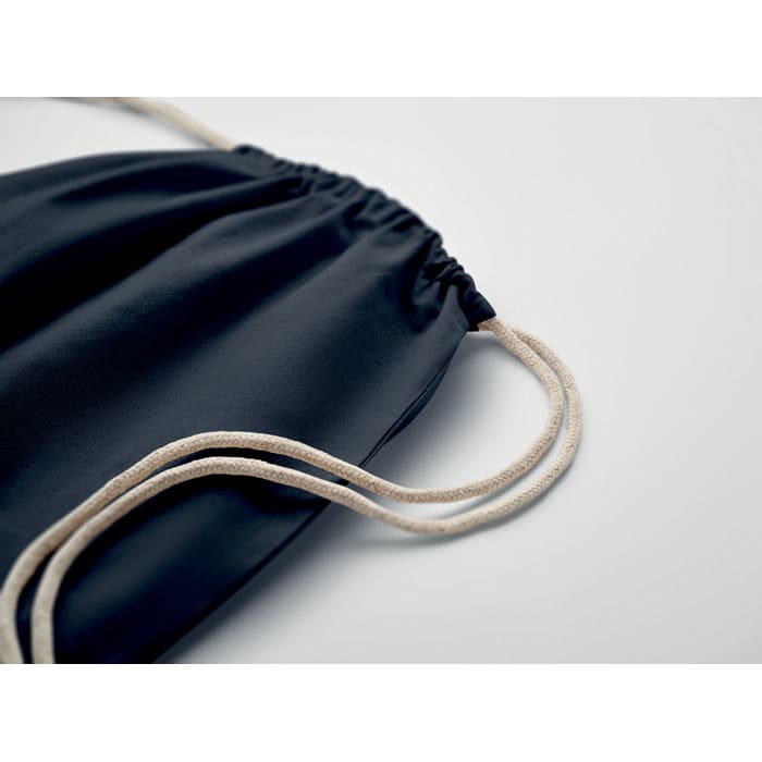 A navy drawstring bag with a gathered top and cream-coloured cords. Features a simple and sleek design.