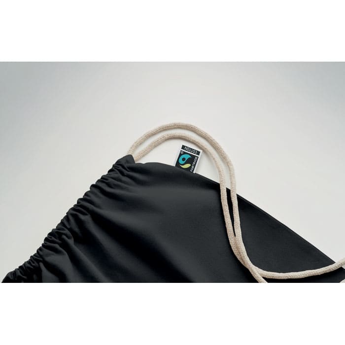 A black drawstring bag with a natural-coloured cord and a small logo on the tag.