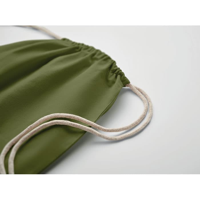 A drawstring bag in olive green with cream-coloured cords. The material appears soft and smooth.