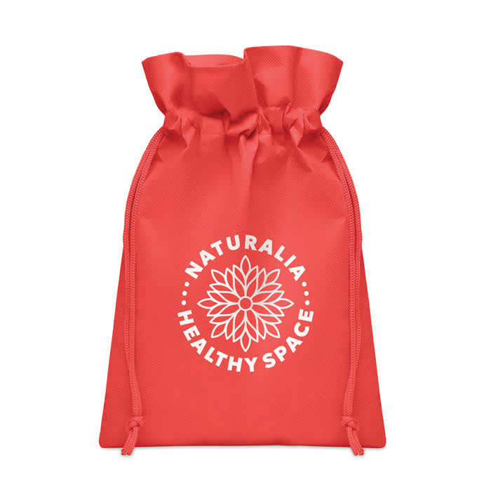 A red drawstring pouch featuring a white logo with floral design and text. The bag is made from a durable material.