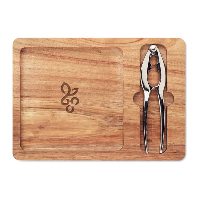A wooden serving board with a stainless steel nutcracker, featuring a logo engraved on the surface.