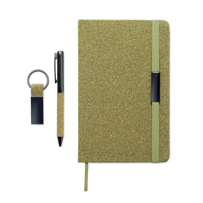 A green notebook with an elastic band, accompanied by a pen and keychain, all featuring a textured finish.