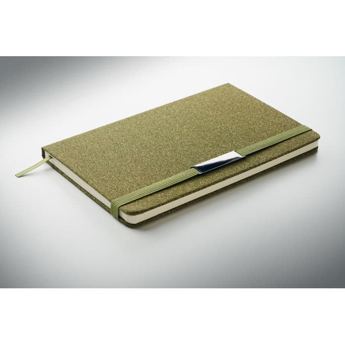 A green notebook with a textured cover and a matching elastic band, featuring a silver clasp.