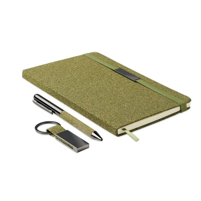A green notebook with a textured cover, accompanied by a pen and a keyring USB drive. The set has a sleek design.