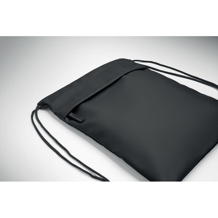 A black drawstring bag with a flap closure and shoulder straps, featuring a simple design.