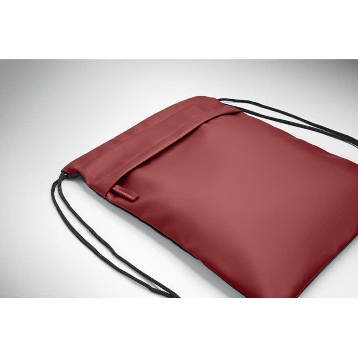 A maroon drawstring bag with a simple design and black cords for closure, featuring a logo.