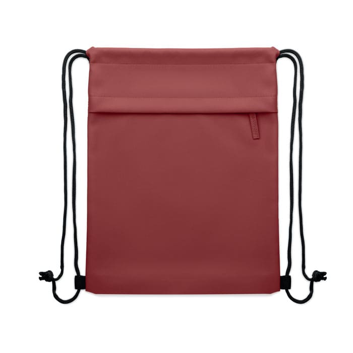 A drawstring bag in a dusty rose colour with black cord straps and a front zip pocket. It features a brand logo.