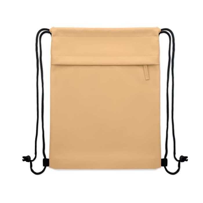 A beige drawstring bag with a front pocket and black cords. It features a simple and sleek design.