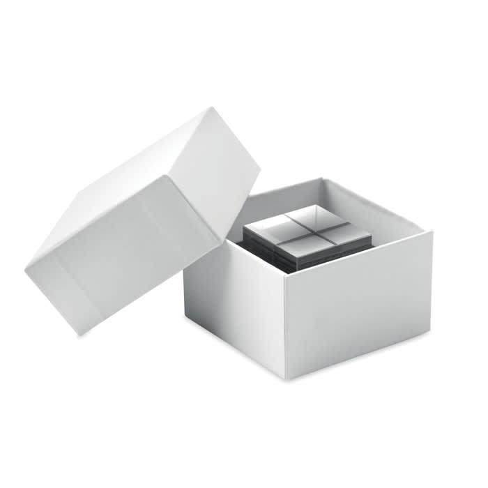 A white gift box is opened, revealing a set of small grey cubes inside. The box features a simple design and has a lid.