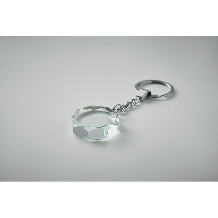 A keyring featuring a faceted clear crystal charm attached to a silver metal chain.