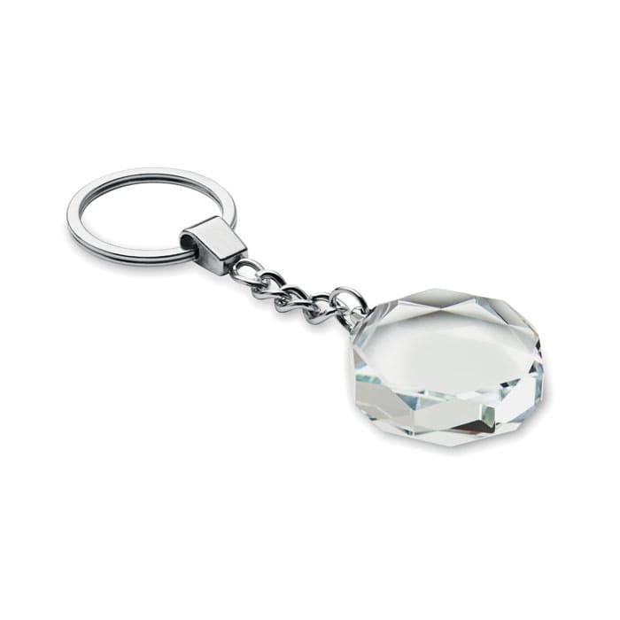 A clear crystal keychain with a silver metal ring, featuring an octagonal geometric shape.
