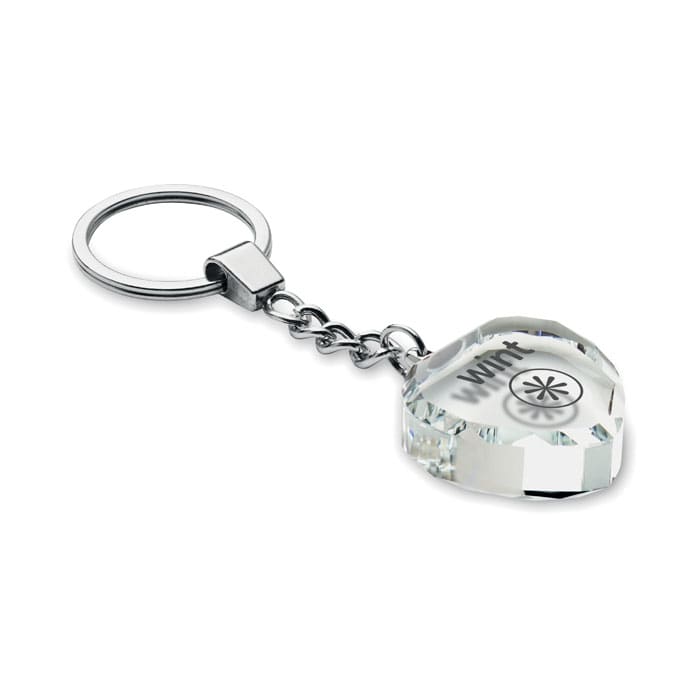 A keychain featuring a faceted clear acrylic charm, attached to a metal ring. The charm has a logo.