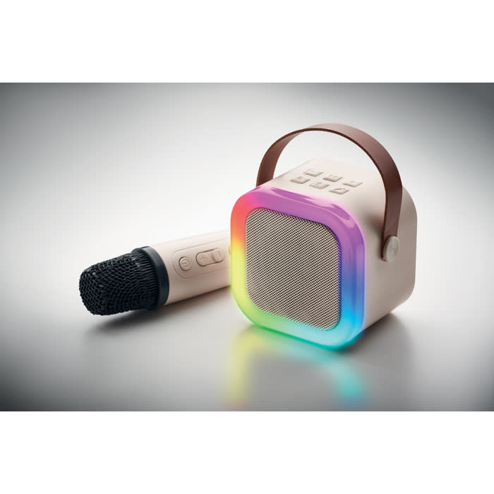 A portable speaker with a rainbow-lit edge, accompanied by a microphone. The speaker is beige with a brown handle.