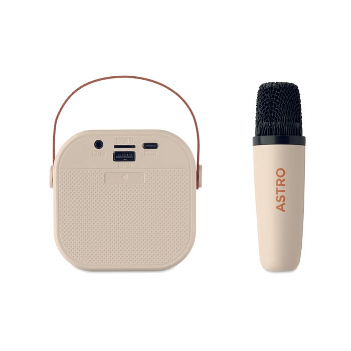 A portable speaker in beige with a carrying handle, paired with a microphone in a matching tone.