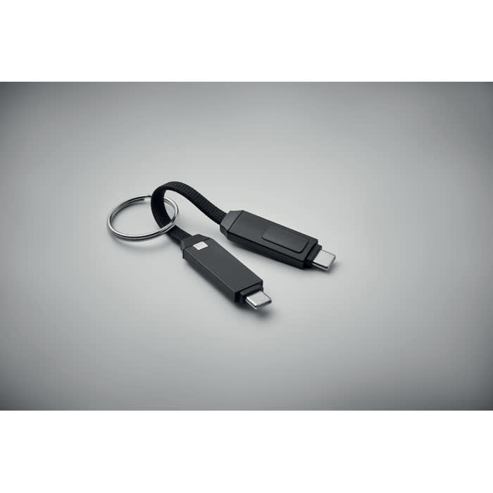 A key ring with two black charging connectors attached, featuring a flexible cable.