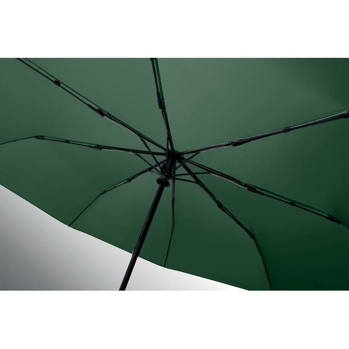 A green umbrella featuring a black frame and open structure, showcasing its internal framework.