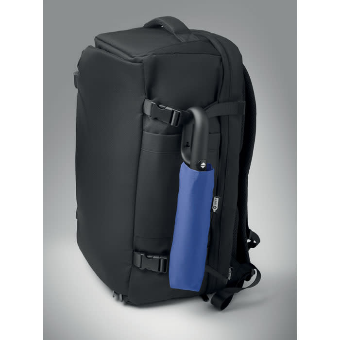 A black backpack with adjustable straps and a side pocket holding a blue umbrella. It features a logo on the front.