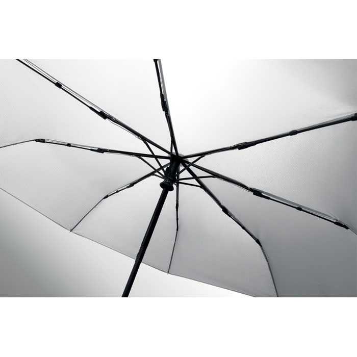 A large umbrella featuring a black frame and white canopy, showcasing its intricate interior structure.
