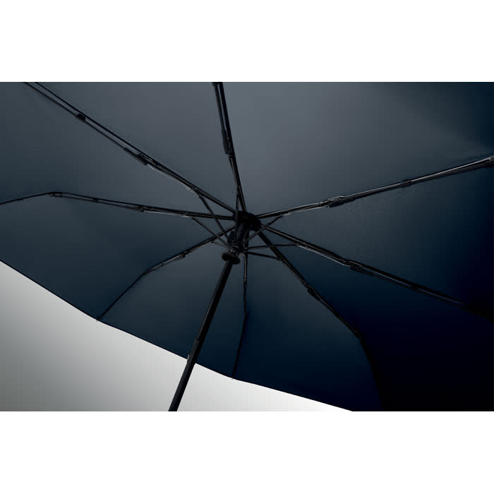 A navy umbrella with a black frame, showcasing its interior structure and ribs. It features a branded logo.