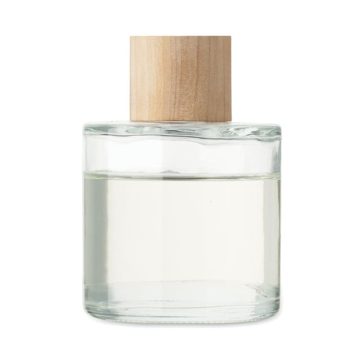 A clear glass bottle with a wooden cap, containing a liquid. The bottle has a simple, elegant design.