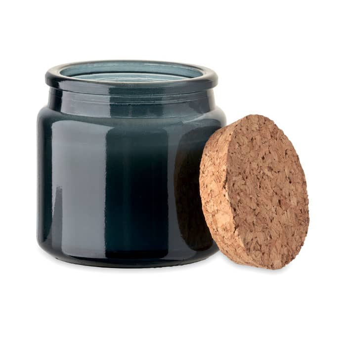 A glass jar with a dark blue tint and a cork lid placed beside it.