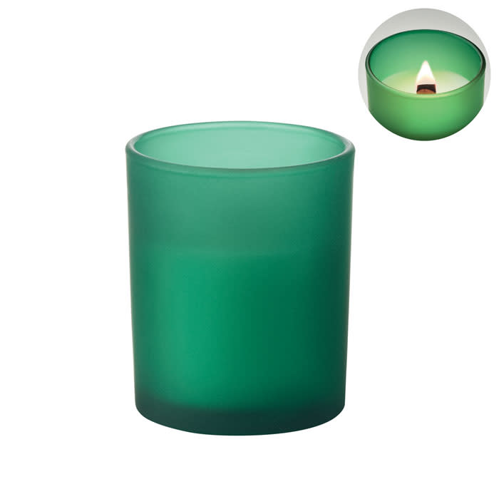 A green candle in a frosted glass holder is displayed, featuring a lit candle inside. The image includes a smaller inset of the flame.