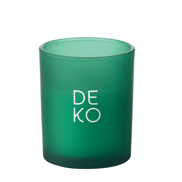A green glass candle holder with a frosted finish and a logo on the front.