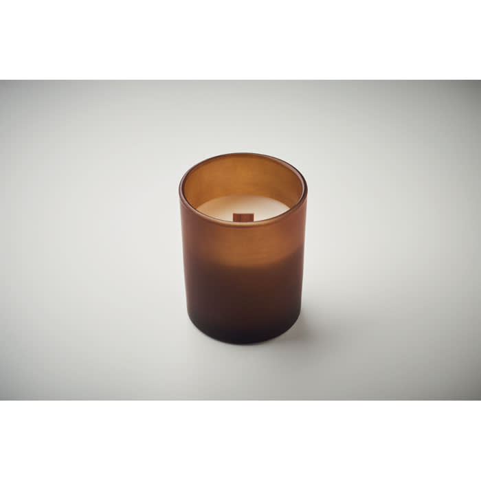 A brown glass candle holder with a white candle inside, featuring a simple, modern design.