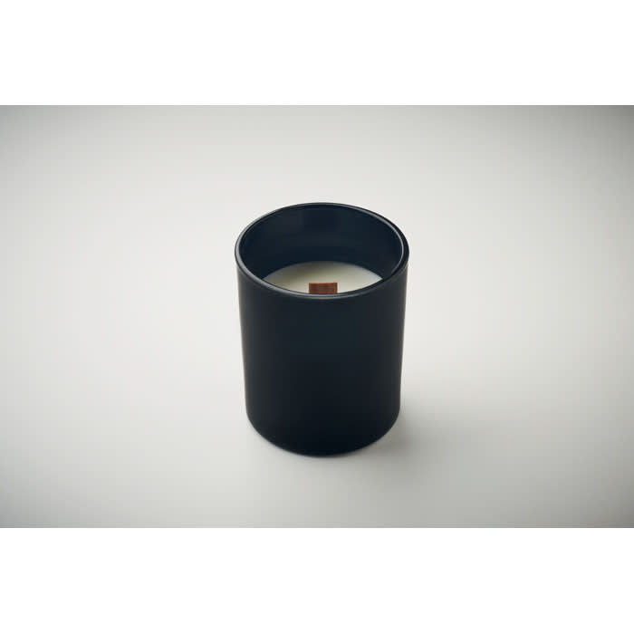 A black cylindrical candle holder with a white candle inside and a wooden wick.