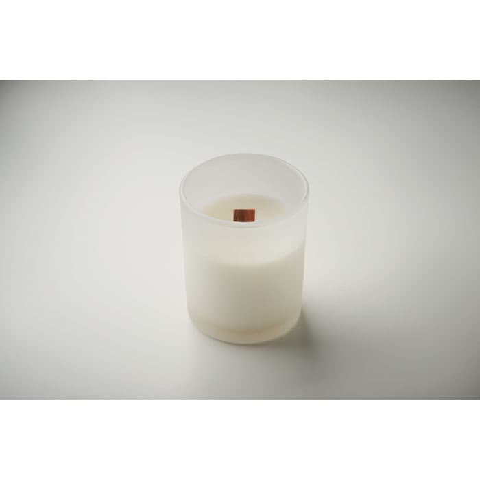 A candle in a frosted glass holder, featuring a wooden wick and a white wax base.