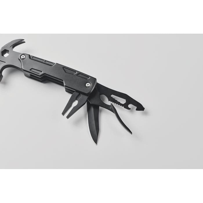 A multitool with a hammer, pliers, and various blades, featuring a sleek black design and metallic accents.