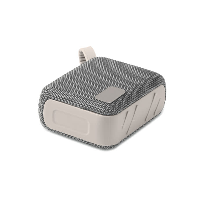 A portable speaker featuring a grey fabric exterior and a smooth white base, with a loop for carrying.
