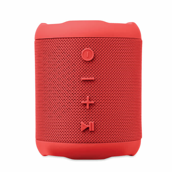 A portable red speaker with textured surface and control buttons for power, volume, and playback.
