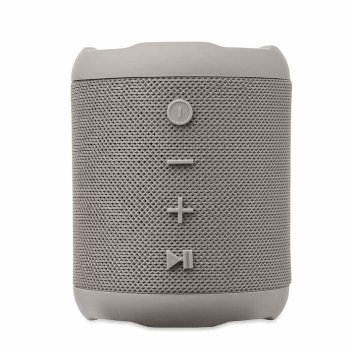 A portable speaker in light grey with control buttons for volume and play functions. It features a textured surface and a logo.